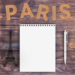 Cardboard Paris Sign with Eiffel Tower, Pen and Blank Notebook with Free Space for Yours Design over Wooden Table. 3d Rendering