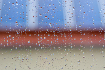 Fototapeta na wymiar Rain drops on window as close up