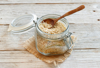 Brown rice in a glass with a spoon