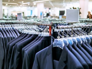 Shop of men's suits. Business clothes, blue jackets