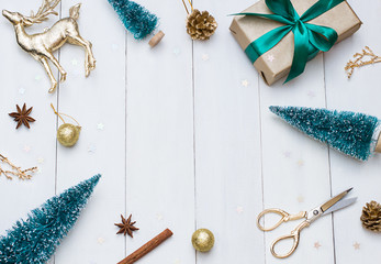 Christmas, New Year white wooden flat lay frame with a gift and deer. Winter holiday concept composition. Copy space