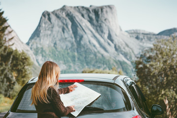 Woman traveling by car on road trip with map planning route Lifestyle concept adventure vacations...