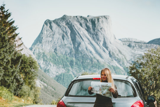 Woman With Map On Road Trip Planning Journey Route In Norway Travel Lifestyle Concept Adventure Vacations Outdoor Mountains On Background