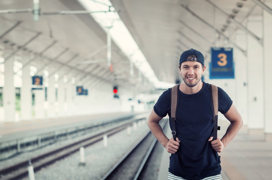 Young Traveler Walking With Backpack On Train Station