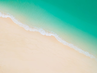 Summer Beach top view or aerial view showing shade of emerald water and wave