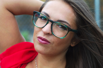 young women portrait close-up glasses red dress
