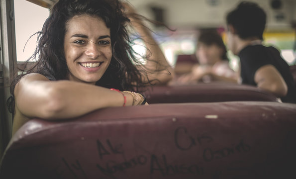 Young woman sitting on school bus