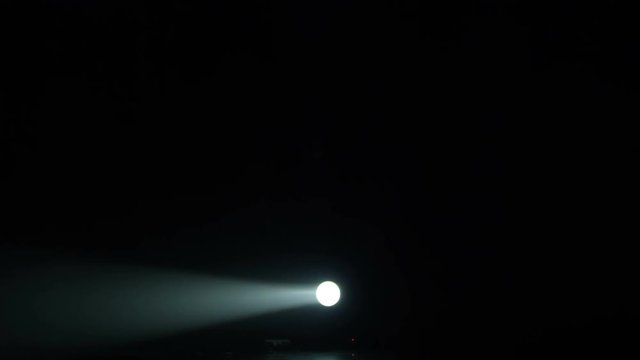 Realistic footage of stage light flashing rays spotlights through smoke. Great as a natural stage background for different projects!!!
