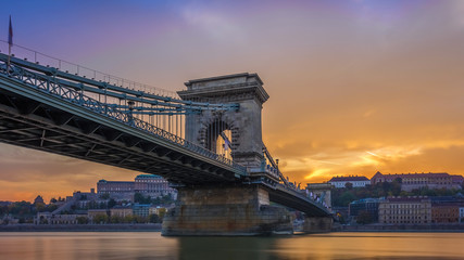 Budapest, Hungary - The beautiful Szechenyi Chain Bridge and Buda Castle Royal Palace with amazing colorful sunset and sky