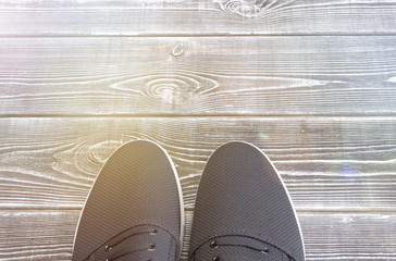 A pair of shoes on a wooden background