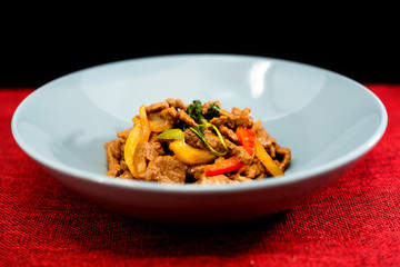 wok fried chicken stir fry with sweet peppers and chinese vegetables