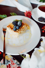 a piece of delicious Napoleon, decorated with blackberries and blueberries