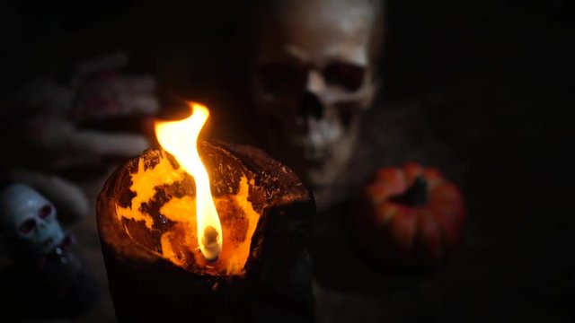 Halloween day footage with skull, pumpkin, candle light, and movement