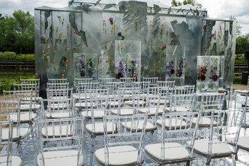 Ice cubes with colorful flowers make a wedding altar on the backyard