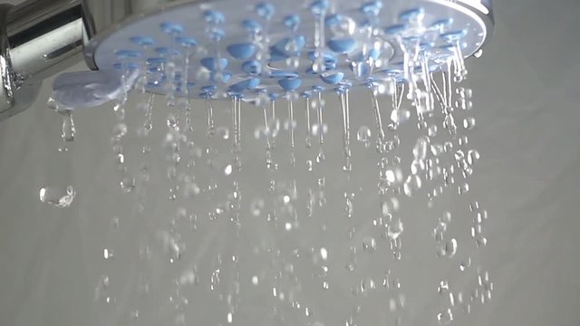 Water sprays out of shower head, slow motion