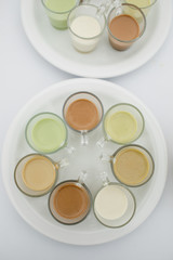 Cups with differed sauces served on white plate