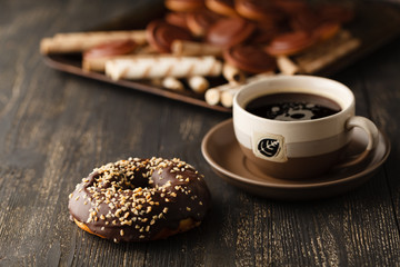 Choco donuts on wooden background.