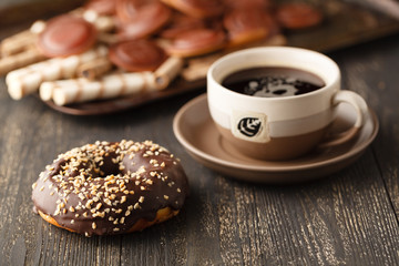 Chocolates background. Chocolate. Cup of hot chocolate, lemon, nuts and assortment of fine chocolates in dark, and milk chocolate on dark wooden table