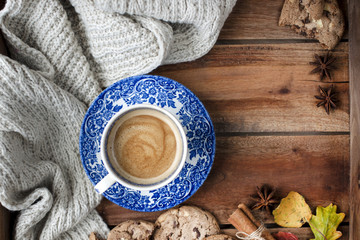 coffee in a vintage cup, on a wooden background with autumn decor and biscuit biscuits