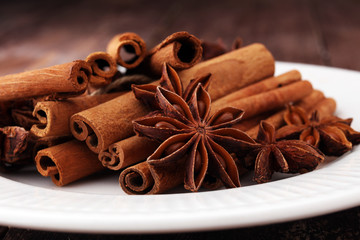 Fragrant star anise and cinnamon on wooden table.