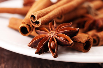 Fragrant star anise and cinnamon on wooden table.