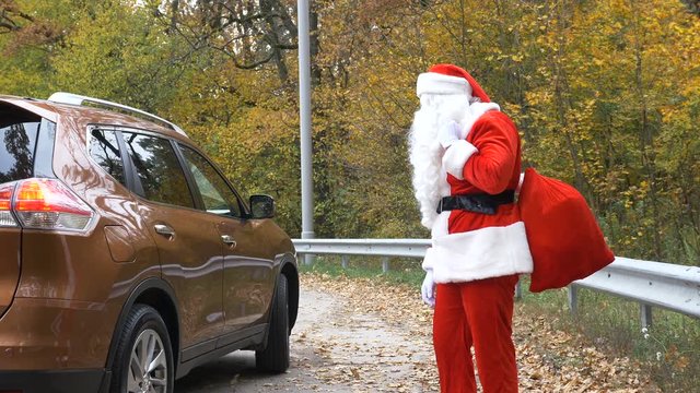 Santa Claus gets into the car with a personal chauffeur 50 fps