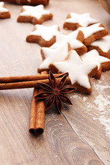 Baking ingredients for homemade pastry on wooden background with cookies and spieces.