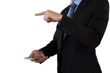 Mid section of businessman in suit gesturing over smart phone