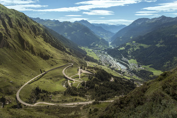 Fototapeta na wymiar Spectacular view at the winding road in the high mountains of Austria, traveling on the Gotthard mountain pass
