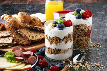 Breakfast served with coffee, orange juice, bread, parfaits and fruits. Balanced diet