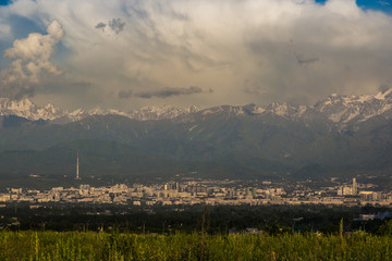 Almaty city panoramic view, Kazakhstan. Cloudy sky, mountains