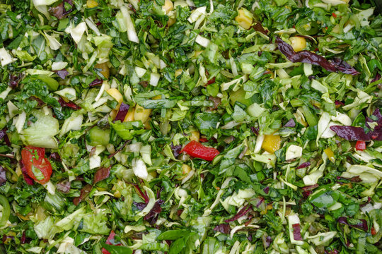 Chopped fresh vegetables prepared as fresh pet food for parrots, the basis of chop. Includes sweet peppers, red cabbage, dark leafy greens, mangetout peas, pak choy, celery, and sweet corn.