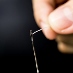 white thread pass to the eye of the needle