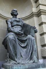 Sculpture  holding a book at the entrance of the government building in Switzerland