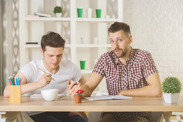 Attractive guys doing paperwork front