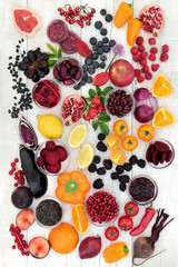 Super food healthy eating concept with health promoting properties of fruit and vegetables high in antioxidants, anthocyanins and vitamins on rustic wood background.  © marilyn barbone