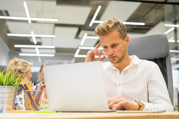 Man in office working on laptop