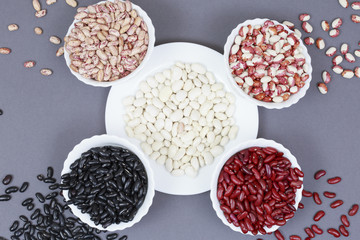 Beans of different colors on plates.