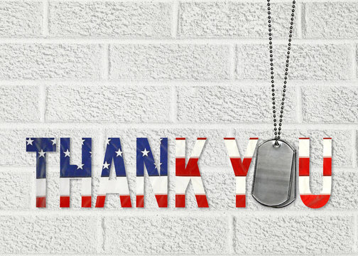 military dog tags and thank you text in American flag pattern on white brick wall