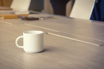 coffee cup on the office desk, business background concept