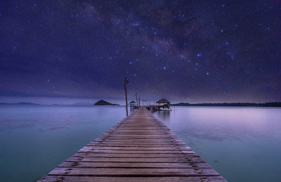 Night View Of Ocean Wood Dock And Milkyway On Sky