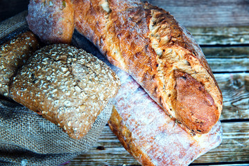 Freshly baked homemade bread on rustic wooden background.