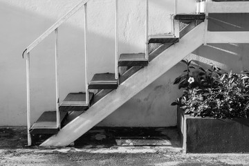 Abstract black and white image side view white small ladder going up.
