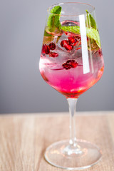 Pomegranate Cocktail Decorated with Mint Leaves and Ice, Cold Drink, Vertical View