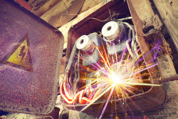 Rusty electric power supply boxes. Industrial background. Overloaded electrical circuit causing...