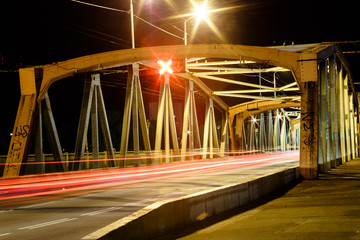 photo of the bridge, taken at night with long exposure, beautiful blur of the headlights of passing cars.