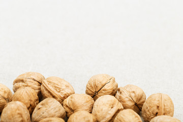 Background of walnuts on a very light blurred cloth. Background food.