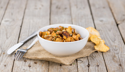 Fresh made Fried Chanterelles on a rustic background