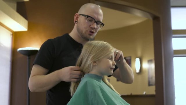 Hairdresser and girl discussing her new hairstyle