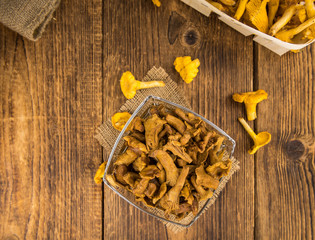 Wooden table with Canned chanterelles, selective focus